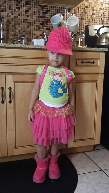 a 3 year old kid in her grandma's kitchen